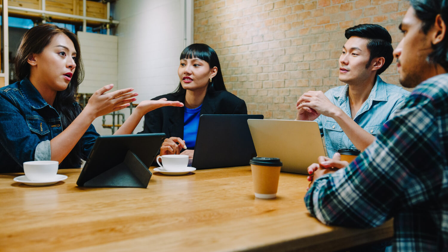 Group of young Asia business coworkers in team casual discussion