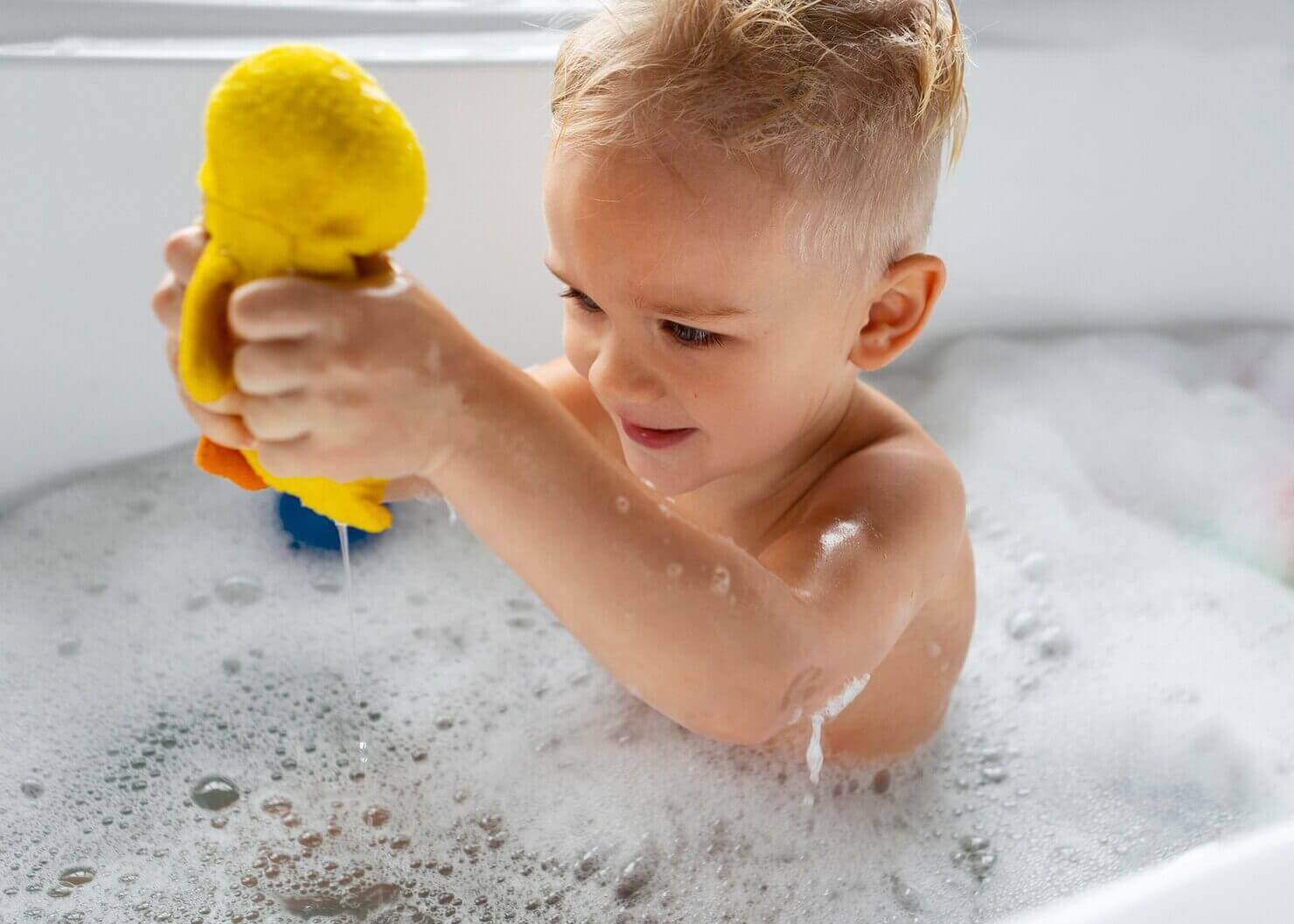 Medium shot boy playing in bathtub