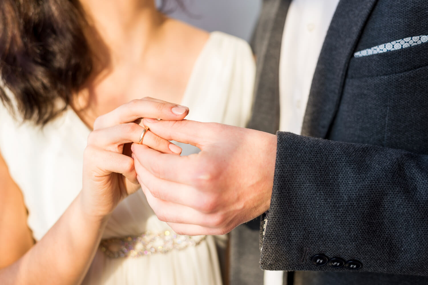 Couple exchanging ring in engagement or wedding
