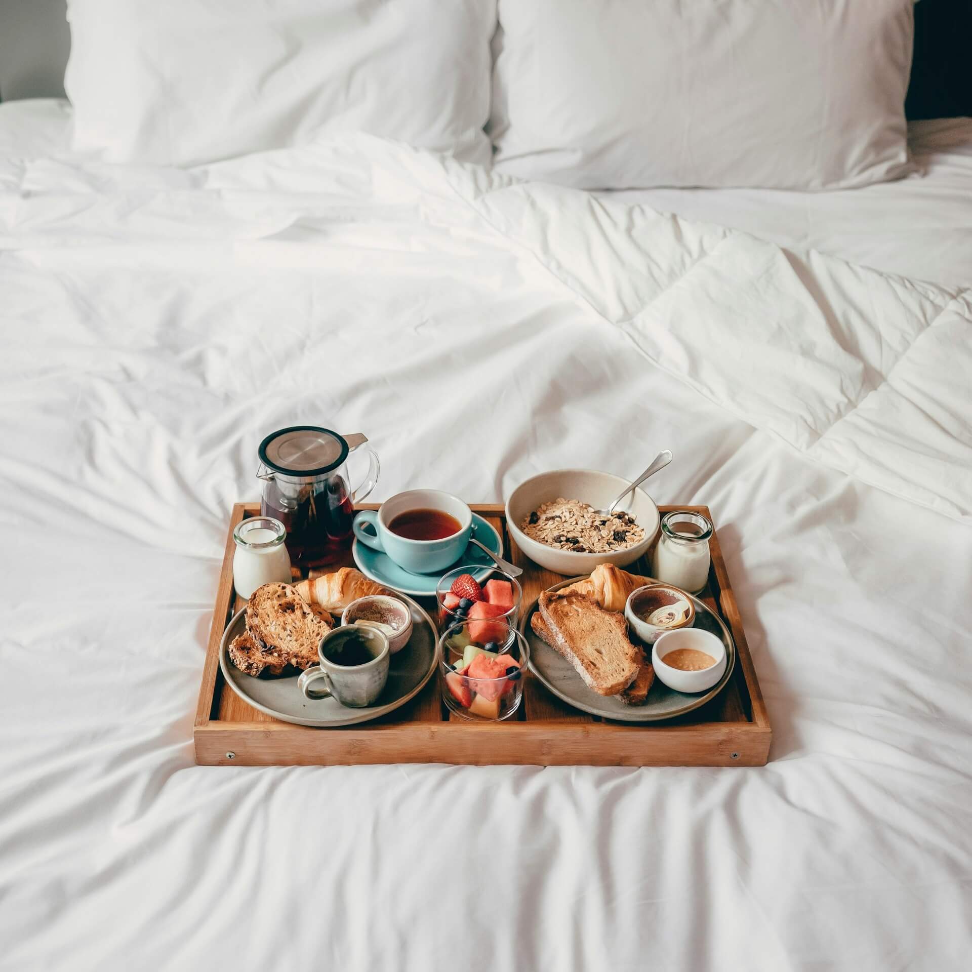 A tray of food sitting on top of a bed natalie sum DZQBffniTO8 unsplash