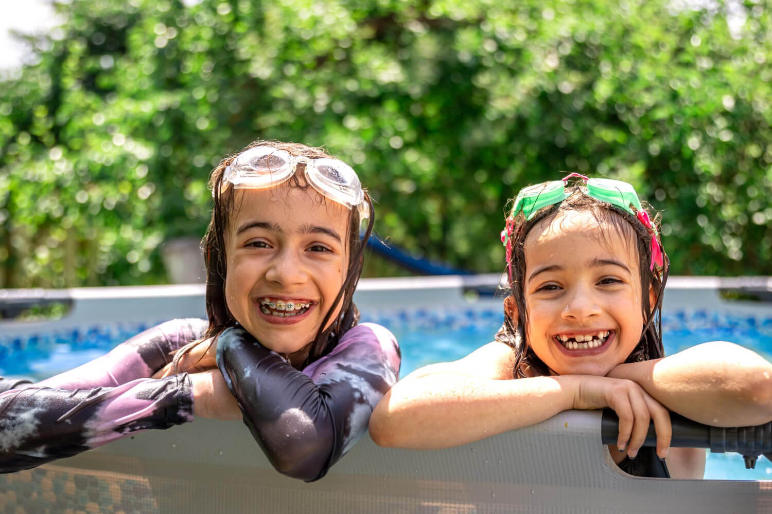 Girls playing in a swimming pool at a summer garden