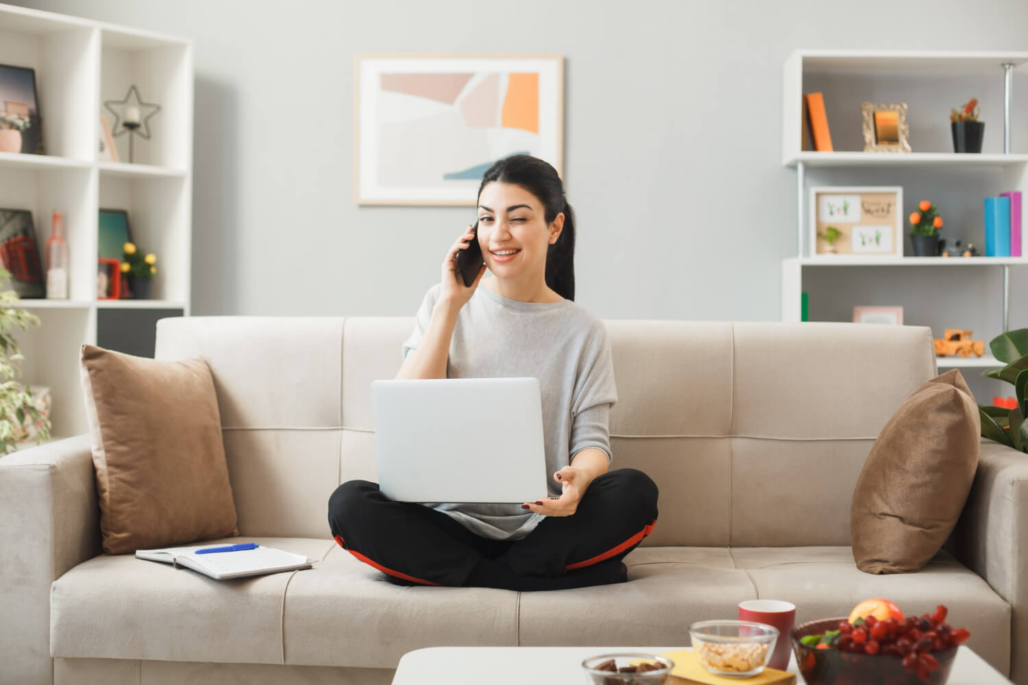 Young girl sitting holding laptop in couch